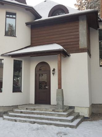 Арочная термодверь со стеклом и ковкой – фото